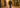 Lifestyle-Aufnahme: Mann in dunkelblauer Jeans, grauem Hoodie und offener Sweatjacke auf einer Allee mit buntem Herbstlaub – tief stehende Nachmittagssonne, klar sichtbare Schichten, dazu braune Chelsea Boots